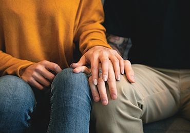 Two people holding hands