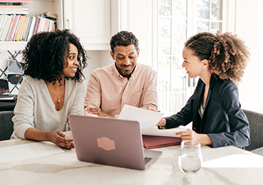 Advisor speaking to clients at their home