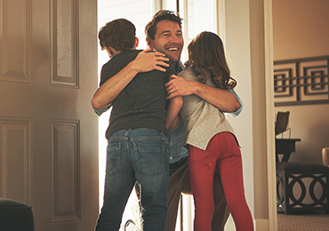 A father embracing his children